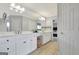 Spacious bathroom featuring a double vanity with white cabinets, neutral countertops, and large mirror at 505 Lighthouse Ln, Peachtree City, GA 30269