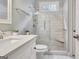 Bright bathroom with a glass enclosed shower, white marble tile and granite topped vanity with framed mirror at 505 Lighthouse Ln, Peachtree City, GA 30269
