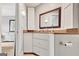 Bathroom vanity with granite countertops, wood framed mirror, and ample storage space at 505 Lighthouse Ln, Peachtree City, GA 30269