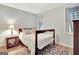 Cozy bedroom with wood floors, neutral walls, and a patterned rug under the bed at 505 Lighthouse Ln, Peachtree City, GA 30269