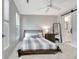 Cozy bedroom with natural light, a full length mirror, and a peek into the bathroom at 505 Lighthouse Ln, Peachtree City, GA 30269