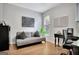 Comfortable bedroom featuring a sofa, desk, and ample natural light at 505 Lighthouse Ln, Peachtree City, GA 30269