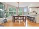 Breakfast nook with a wooden table and bench seating next to a kitchen with white cabinets at 505 Lighthouse Ln, Peachtree City, GA 30269