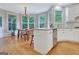 Breakfast nook with large windows, hardwood floors, and white kitchen cabinets at 505 Lighthouse Ln, Peachtree City, GA 30269