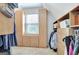 Angled walk-in closet with custom shelving with window and lots of natural light at 505 Lighthouse Ln, Peachtree City, GA 30269