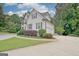 Elegant two-story home featuring a white facade, dark shutters, manicured landscaping, and a circular driveway at 505 Lighthouse Ln, Peachtree City, GA 30269