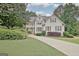 Charming two-story home with a well-manicured lawn and beautiful landscaping at 505 Lighthouse Ln, Peachtree City, GA 30269
