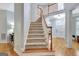 Bright foyer with hardwood floors, staircase, and front door at 505 Lighthouse Ln, Peachtree City, GA 30269