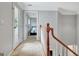 Upstairs hallway showcasing the staircase, a view of a bedroom, and a door to an outside deck at 505 Lighthouse Ln, Peachtree City, GA 30269