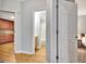 Hallway with wooden floors, a kitchen, a bathroom, and a bedroom can be seen through the doorways at 505 Lighthouse Ln, Peachtree City, GA 30269
