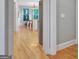 Bright hallway leading to the kitchen and dining area with hardwood floors at 505 Lighthouse Ln, Peachtree City, GA 30269
