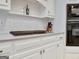 Close-up of a stove top and white cabinets, with a black built-in oven to the side at 505 Lighthouse Ln, Peachtree City, GA 30269