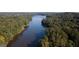 Scenic aerial view showcasing a tranquil lake surrounded by dense, green forest at 505 Lighthouse Ln, Peachtree City, GA 30269
