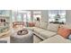 Open-concept living room with a large sectional sofa, connected to dining area and kitchen at 505 Lighthouse Ln, Peachtree City, GA 30269