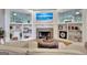 Cozy living room with a fireplace, built-in shelves, and a large television for entertainment at 505 Lighthouse Ln, Peachtree City, GA 30269