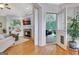 Open-concept living room with hardwood floors, a fireplace, and a doorway to the porch at 505 Lighthouse Ln, Peachtree City, GA 30269