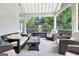 Relaxing outdoor living space with comfortable seating, TV, and a peaceful view of the surrounding greenery at 505 Lighthouse Ln, Peachtree City, GA 30269
