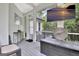 Comfortable outdoor living space with mounted tv, clock, and outdoor storage at 505 Lighthouse Ln, Peachtree City, GA 30269