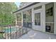 View of the pool and outdoor living space with stairs leading down from the covered porch at 505 Lighthouse Ln, Peachtree City, GA 30269