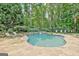 Beautiful kidney-shaped pool with a stone waterfall feature and ample lounging space at 505 Lighthouse Ln, Peachtree City, GA 30269
