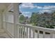 Covered porch featuring white railing and a view of the front lawn and beautiful landscaping at 505 Lighthouse Ln, Peachtree City, GA 30269