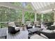 Covered porch with ceiling fan and white railings offering plentiful seating with wicker furniture at 505 Lighthouse Ln, Peachtree City, GA 30269