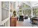 Covered porch with vaulted ceiling, white railings and multiple seating areas and wicker furniture at 505 Lighthouse Ln, Peachtree City, GA 30269