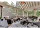 A screened porch with comfortable seating, ceiling fans, and views of the surrounding trees at 505 Lighthouse Ln, Peachtree City, GA 30269