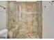Walk-in tiled shower with mosaic floor, shower head, clear glass wall, and convenient bench at 505 Lighthouse Ln, Peachtree City, GA 30269