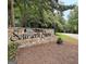 Neighborhood sign of 'Southern Shore' made of stone, surrounded by lush trees at 505 Lighthouse Ln, Peachtree City, GA 30269