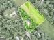 Aerial view of the property showcasing the house, land, and surrounding trees at 135 Crimson Rdg, Tyrone, GA 30290