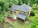 Aerial view of the home featuring a screened porch, patio, and mature landscaping at 135 Crimson Rdg, Tyrone, GA 30290