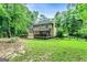 Spacious backyard featuring a covered porch and mature trees, offering a private and relaxing outdoor space at 135 Crimson Rdg, Tyrone, GA 30290