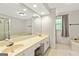 Well-lit bathroom with a double vanity, a soaking tub, and a separate glass-enclosed shower at 135 Crimson Rdg, Tyrone, GA 30290