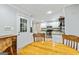 Dining area looking towards kitchen with stainless steel appliances and granite counters at 135 Crimson Rdg, Tyrone, GA 30290