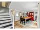 Bright dining room with a wooden table, classic chairs, and a red hutch on a patterned rug at 135 Crimson Rdg, Tyrone, GA 30290