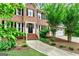 Charming two-story brick home with black shutters, a black front door, and a manicured front yard at 135 Crimson Rdg, Tyrone, GA 30290