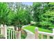Landscaped front yard featuring a stone walkway, lush greenery, and mature trees, enhancing the property's curb appeal at 135 Crimson Rdg, Tyrone, GA 30290