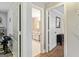 Hallway with multiple doors, one leading to a bathroom with tile flooring at 135 Crimson Rdg, Tyrone, GA 30290