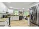 Bright and spacious kitchen with white cabinets, modern appliances, and granite countertops at 135 Crimson Rdg, Tyrone, GA 30290