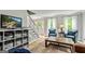Open living room with hardwood flooring, blue chairs, brown sofa, and a staircase on the side at 135 Crimson Rdg, Tyrone, GA 30290
