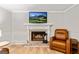 Living room with fireplace and brown leather chair at 135 Crimson Rdg, Tyrone, GA 30290
