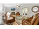 Inviting living room with fireplace, leather furniture, and access to back patio at 135 Crimson Rdg, Tyrone, GA 30290