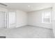 Bright bedroom with neutral walls, plush carpet, and a large window at 493 Prescott Way, Villa Rica, GA 30180
