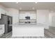 Modern kitchen features granite island, stainless steel appliances, and ample cabinet space at 493 Prescott Way, Villa Rica, GA 30180