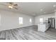 Open-concept living space with gray floors flowing into a modern kitchen area at 493 Prescott Way, Villa Rica, GA 30180