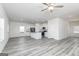 Open-concept living space with gray floors flowing into a modern kitchen at 493 Prescott Way, Villa Rica, GA 30180