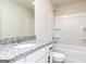 Bathroom featuring a granite countertop vanity, a mirror and a shower/tub at 481 Prescott Way, Villa Rica, GA 30180