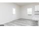 Dining area featuring gray wood-look floors, a white door, and a large window at 481 Prescott Way, Villa Rica, GA 30180