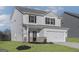 Two-story home showcasing light siding, black shutters, covered porch, and attached two-car garage at 481 Prescott Way, Villa Rica, GA 30180
